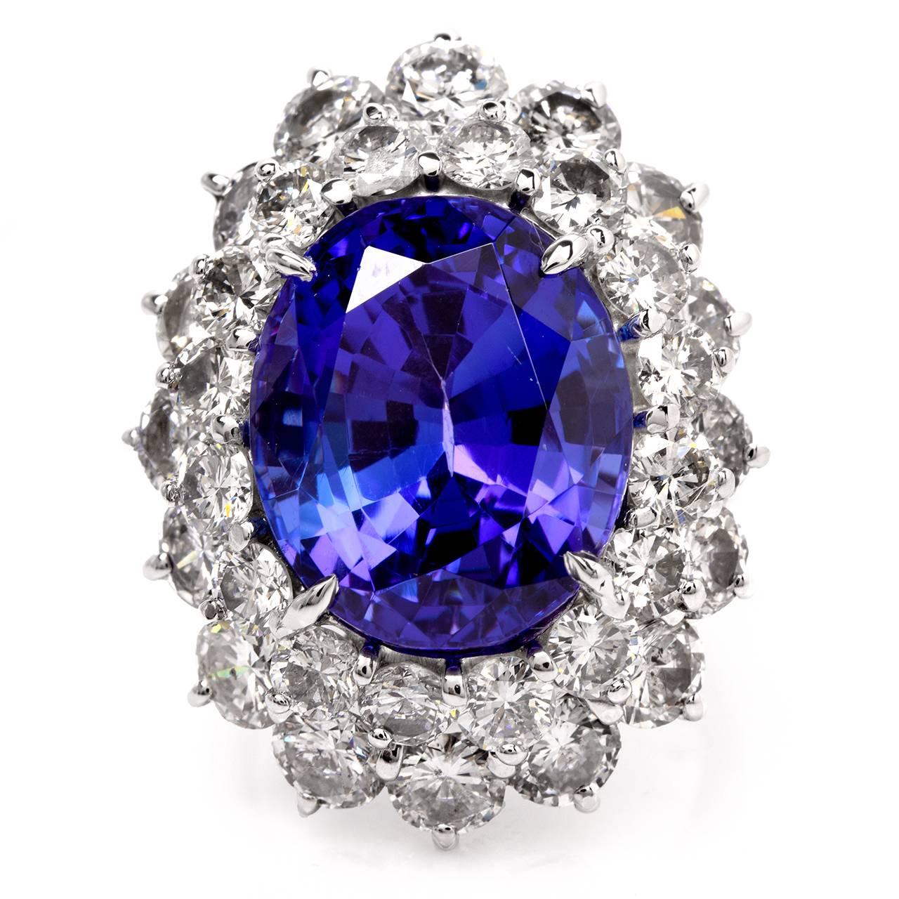 This Stunning cocktail ring is crafted in solid platinum. It exposes at the center a prominent GIA certified oval faceted tanzanite weighing approx. 17.29 cts surrounded  by 32 genuine round-faceted  diamonds cumulatively weighing  9.42cts, graded 