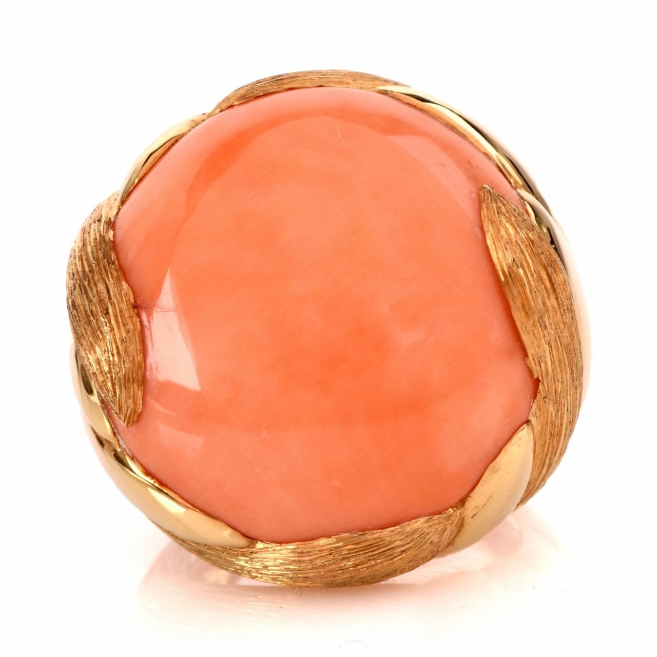 This estate Retro cocktail ring of opulent design is crafted in a combination of matted and polished 18K yellow gold, weighs 27.4 grams. The ring measures 26 mm wide x 10 mm high. This quintessentially Retro design cocktail ring exposes a round