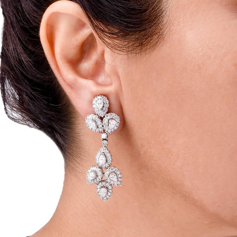 These exquisite diamond chandelier earrings of affluent and sophisticated monochromatic aesthetic are inspired by the 19th century Iberian Girandole style crafted in solid 18k white gold weighing approx. 23.3 grams and measuring 53 mm long and 18 mm