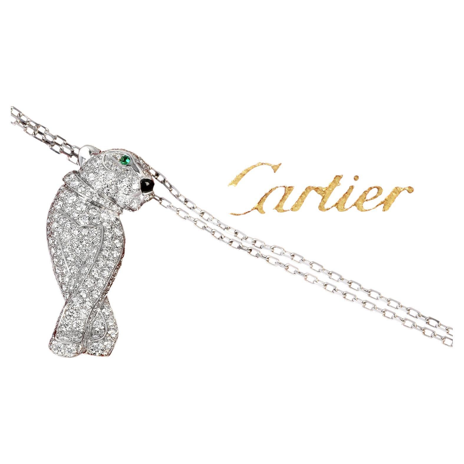 Cartier 'Panthère De Cartier' panther pendant necklace set in 18k white gold.

This stunning Cartier's iconic panther motif and is made of 18k white gold. The panther face is set with two round cut emerald tsaverite eyes and an onyx nose. The