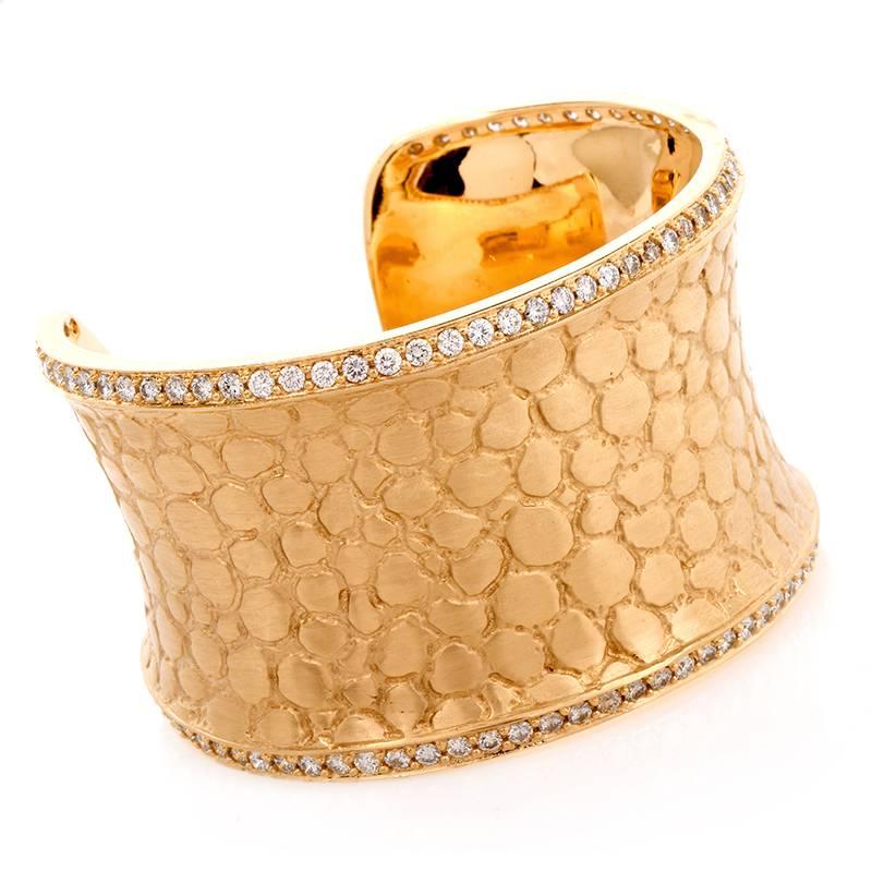 This sensuous estate wide bangle bracelet of German provenance is a design by Gert Helmuth. The wide bracelet of unique aesthetic beauty belongs to his 'splendor' collection. This gracefully curvaceous cuff bracelet is handcrafted in solid 18k