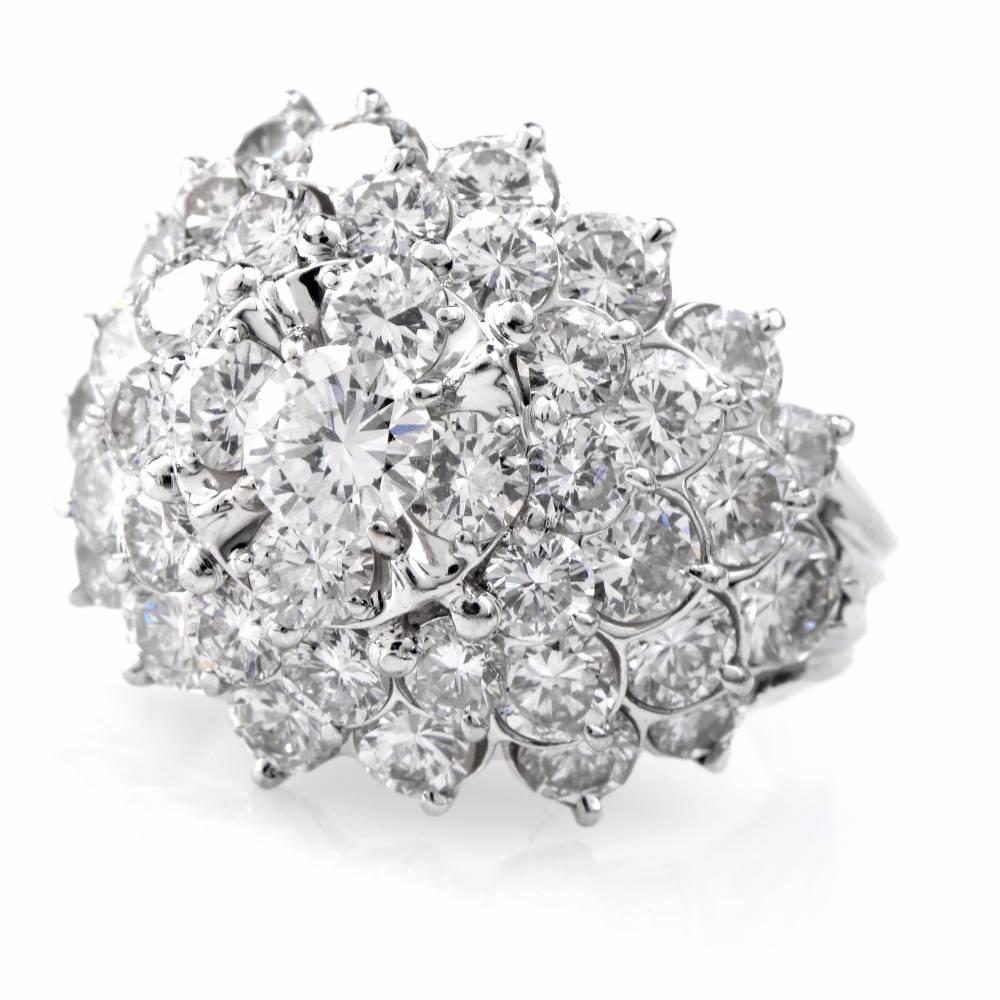 This fashionable ring is crafted in solid platinum. Exposing a sparkling bombe plaque, this classically elegant ring is adorned with 5.10cts of pave-set round-faceted diamonds graded F-G color and VS1 clarity. This diamond cluster ring features a