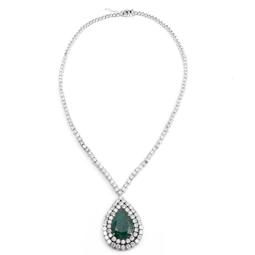 This absorbing and classically elegant necklace is crafted in solid 18K white gold. This necklace incorporates a pear-shaped pendant centered with a prominent faceted pear-shape emerald (with natural inclusion) weighing approx. 18.40cts, surrounded