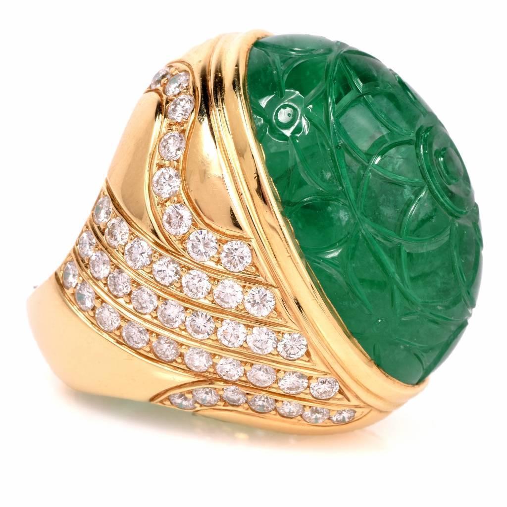 This magnificent Emerald and Diamond cocktail ring is crafted in solid 18K yellow gold. This impressive cocktail ring is centered with a genuine Cabochon carved floral Emerald (with natural inclusions and minor cedar oil treatment) approx: