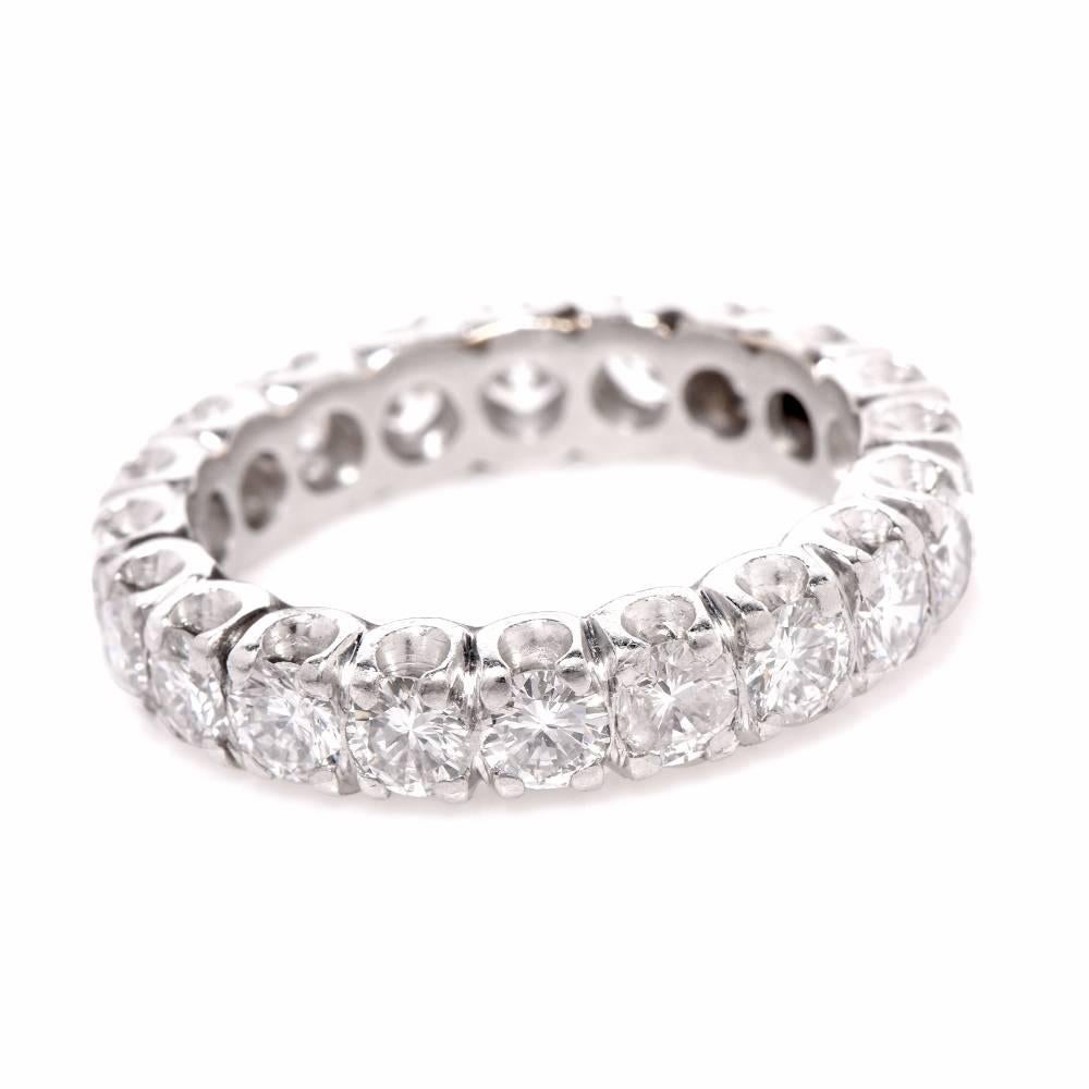 This Vintage eternity ring of captivating aesthetic and timeless elegance is crafted in platinum. It is adorned with 14 round-faceted diamonds of 2.38 carats of high quality diamond  G-H color, VS1-VS2 Clarity.. This classic vinatge eternity band