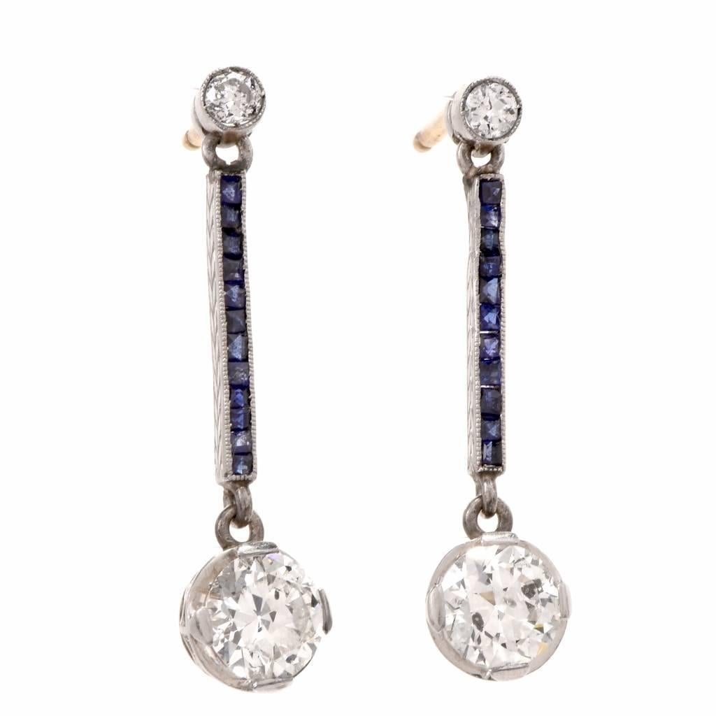 These Antique drop earrings from the Art Deco era are crafted in solid platinum, with 18 carat yellow gold posts and clasps. They expose four European cut diamonds weighing cumulatively 1.85cts, graded H-I color and SI2 clarity ( few Inclusion),