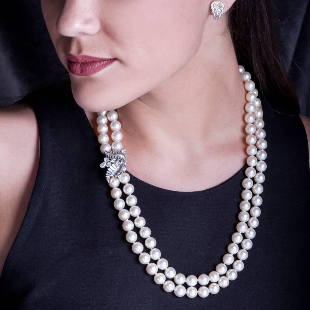 This eye-catching estate pearl necklace incorporates two strands of silk-strung 10mm lustrous Akoya pearls of excellent nacre, and of enchanting white with a very subtle hue of pink color. The two strands are composed of 110 well matched Japanese