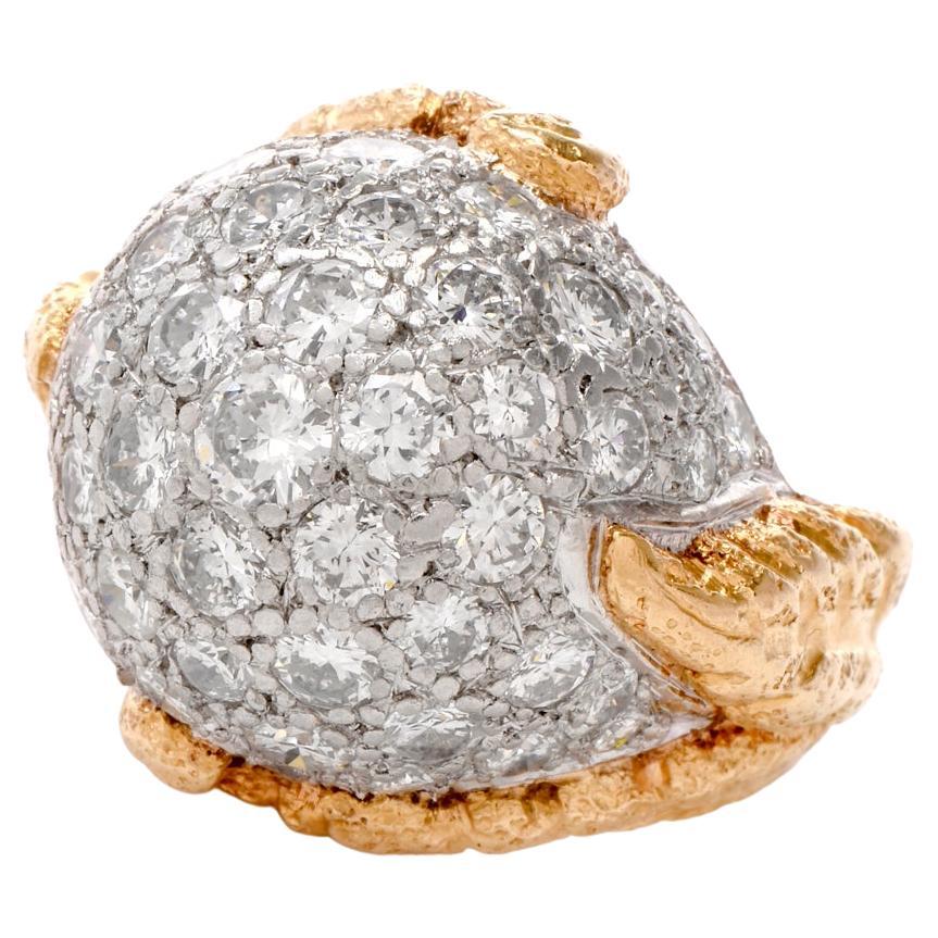 This alluringly beautiful cocktail ring exposes a domed plaque and Art Nouveau inspired relief enhancements of naturalistic motifs and texturing of gold, It is crafted in finely textured matted 18 karat yellow gold and solid platinum as base for