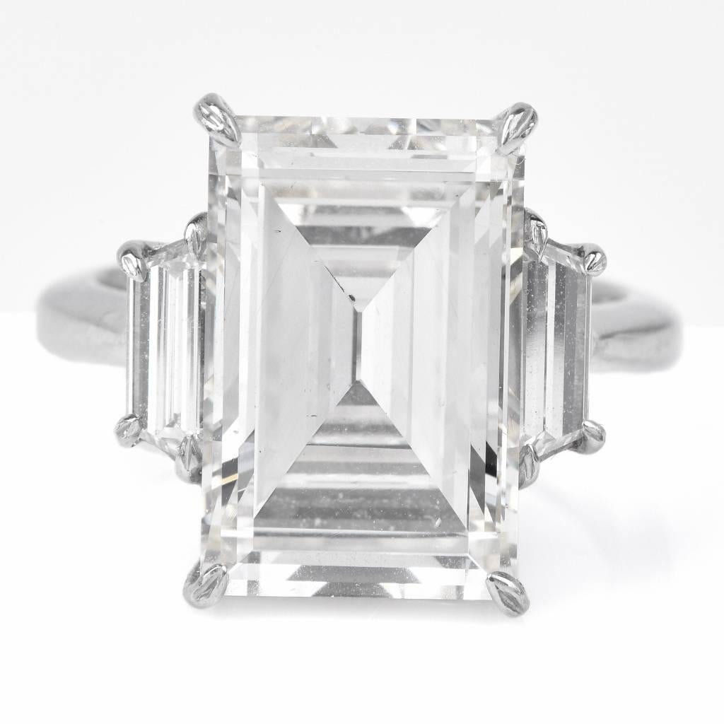 This conspicuous estate engagement ring with an outstanding diamond at the center is crafted in solid platinum and weighs approx. 12.7 grams. This affluent engagement ring of elegant monochromatic aesthetic exposes an 8.04ct emerald-cut diamond