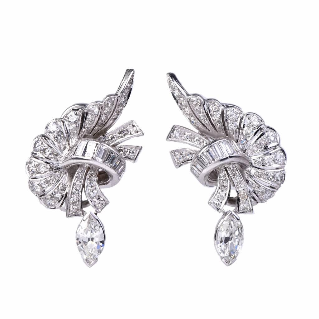 These  estate  earrings of extravagant aesthetic and outstanding elegance are crafted in platinum,  weighing approx. 19.00 grams and measuring 35 mm long .  Of elegant naturalistic design, these earrings expose an assemblage of genuine marquise
