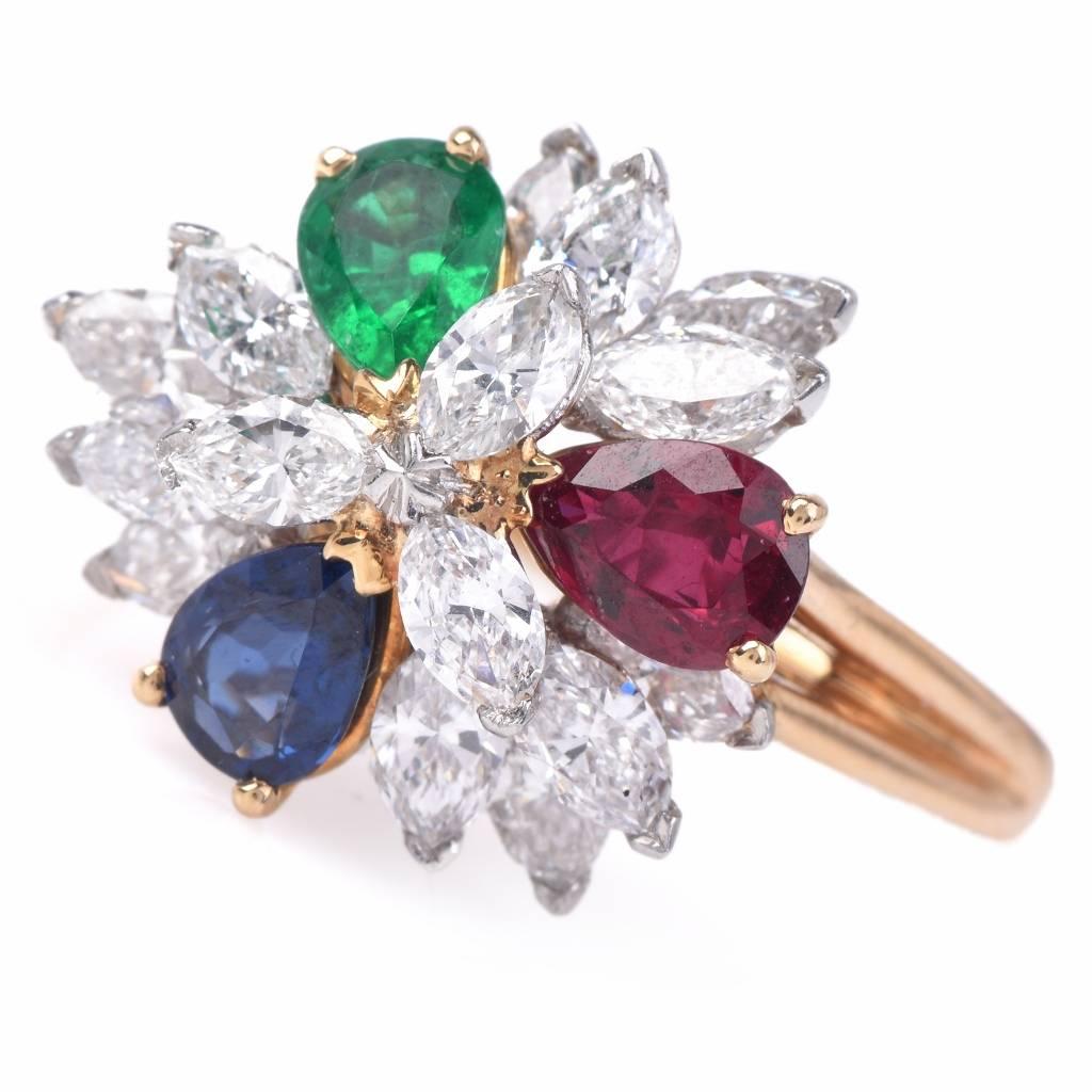 This exquisite Oscar Heyman cluster ring is finely crafted in solid 18K yellow gold and platinum. It is accented with 15 genuine marquise cut diamonds approx. 3.01 ct, F-G color, VS1 clarity, 1 genuine pear cut red ruby approx. 0.73 ct, 1 genuine