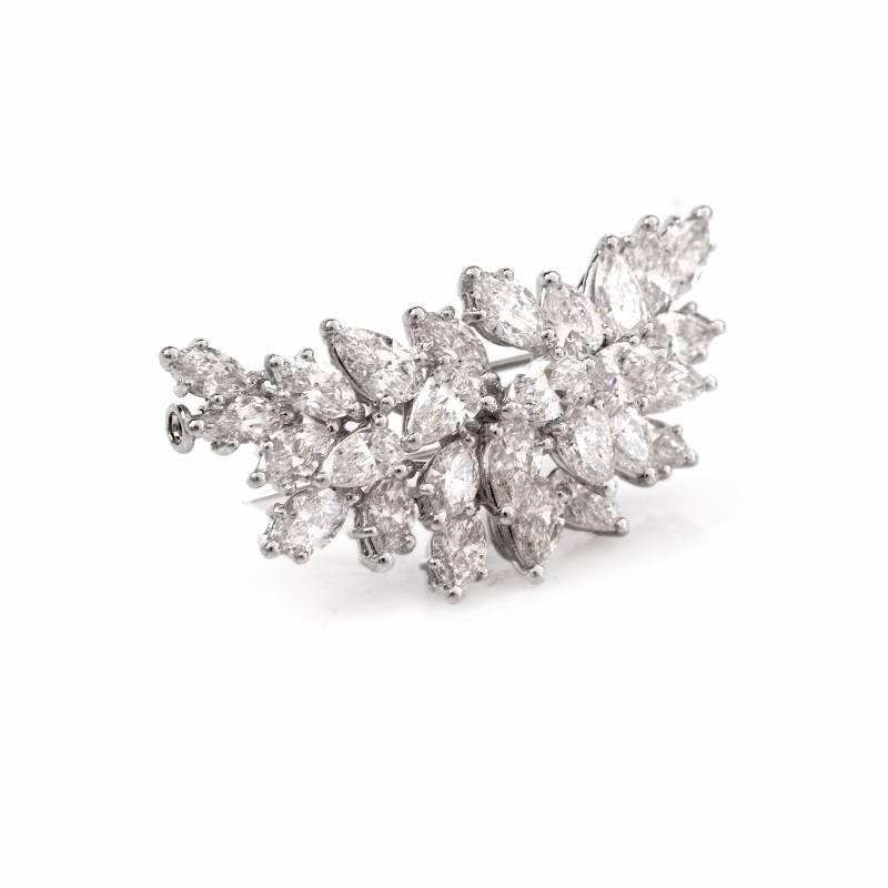This alluringly  beautiful estate diamond lapel brooch of unique monochromatic aesthetic is crafted in solid platinum , weighing 12.4 grams and measuring 44 x 20 mm.  The highly sparkling lapel brooch is resplendent in 27 high grade marquise and