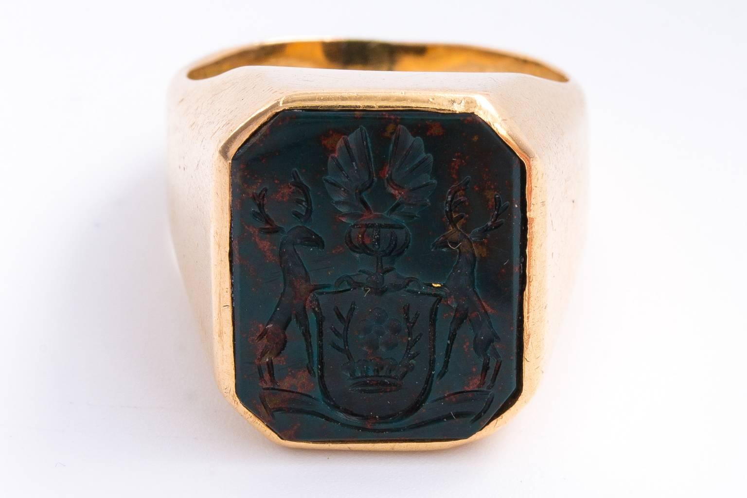 Beautifully carved figural family crest intaglio set into a sophisticated 14ct gold shank and setting. Intaglio may be 18th century or earlier. Setting is 19th century. Ring size is 8.5. Weight is 19.30 grams.