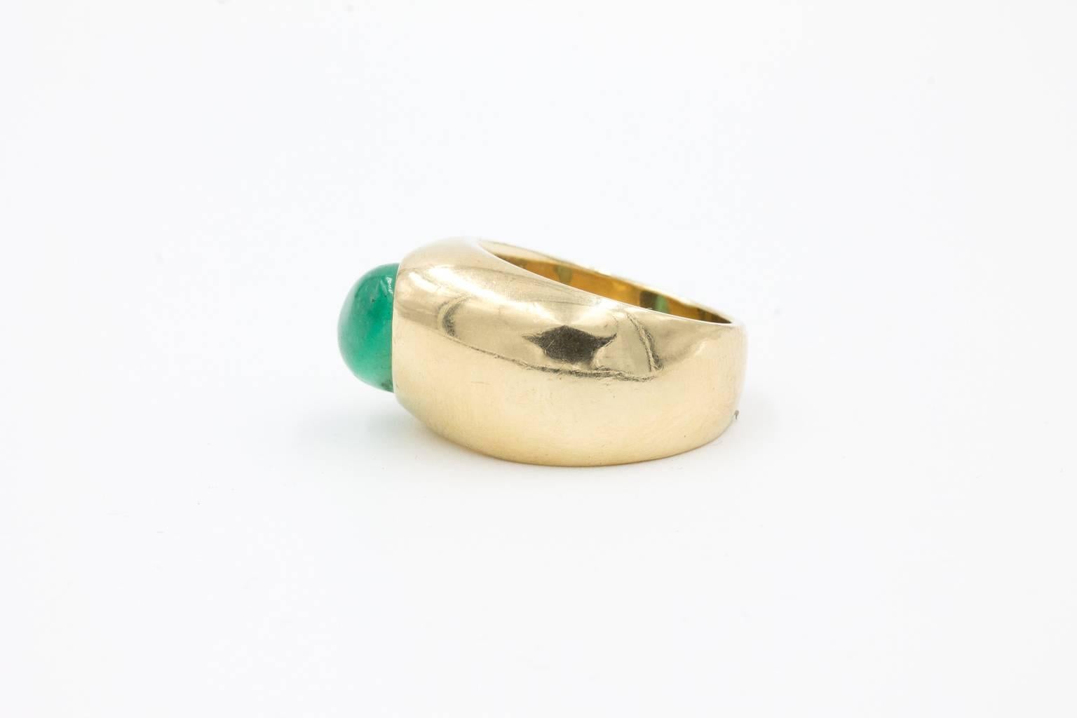 The ring features a cabochon cut deep green emerald 11.5 X 7 mm estimated at 4 carats. The ring is mounted on a asymmetric modernistic design solid gold shank with a total 15.5 grams. Currently size 6, re-sizable, stamped 14K on the inside of the