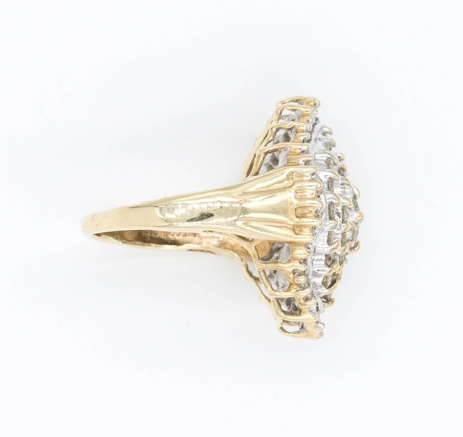 Dazzling statement ring constructed from solid 14K yellow gold and diamonds. Diamonds are round in the center and baguettes on the outer border. They weigh 2 carats in total (200 DT). The ring was crafted in the 1970s and is marked 14K and has a