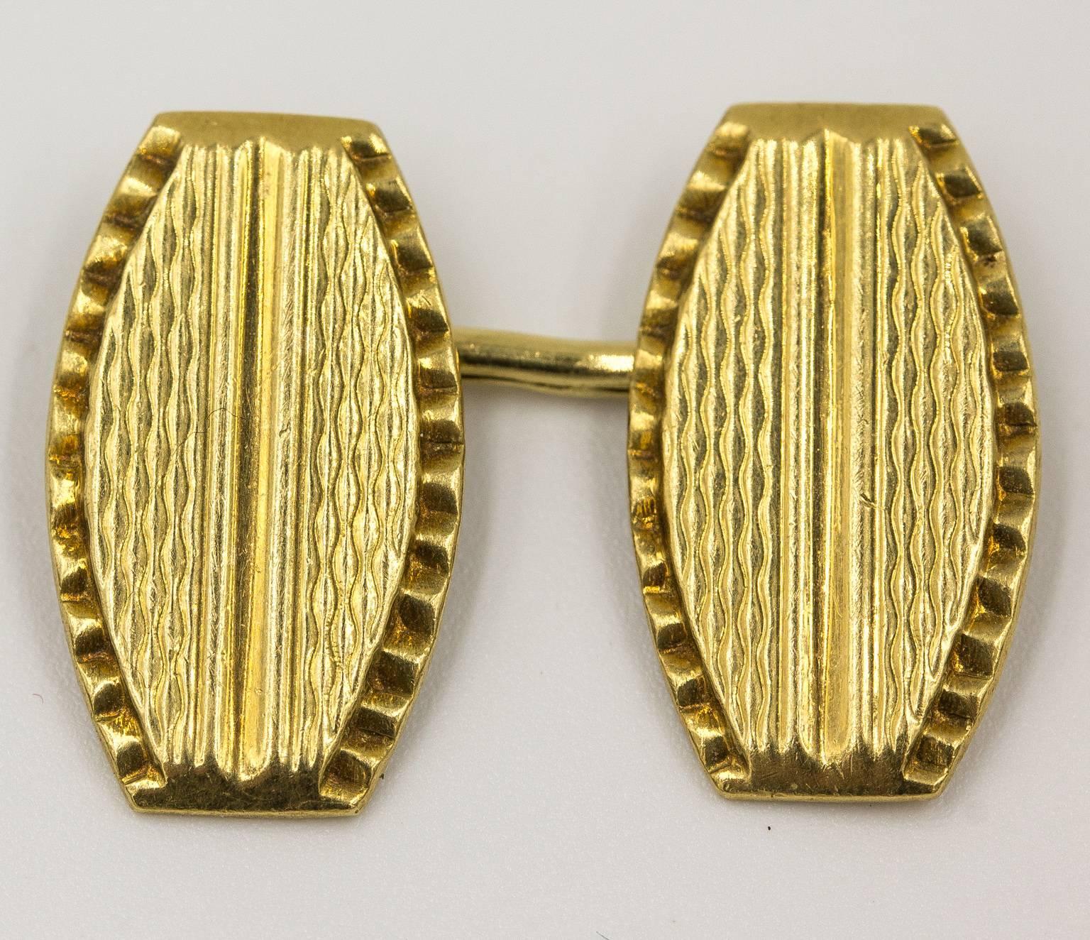 Vintage cuff links made from solid 18 KT yellow gold. Marked 750 for gold content. Lovely guilloche patterns on top. Double sided. Connected with links. Easy to wear. Weighs 10 grams total.