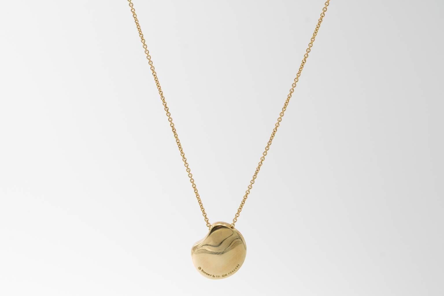 Classic pendant and chain constructed from solid 18 KT yellow gold. Believed to be either cat island isle shell style or bean or broad bean pendant. Substantial yet not too showy. Great for daily wear. Pendant is about 7/8 inches in size, chain is