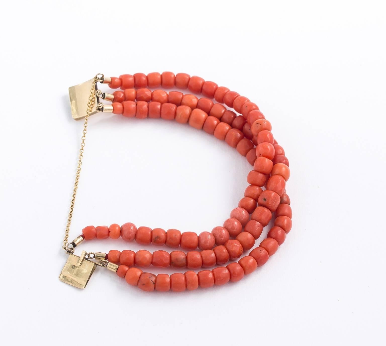 Three strand natural coral bracelet with a 14 kt. box clasp. Includes hand cut square and round beads. Length-7.00 inches.