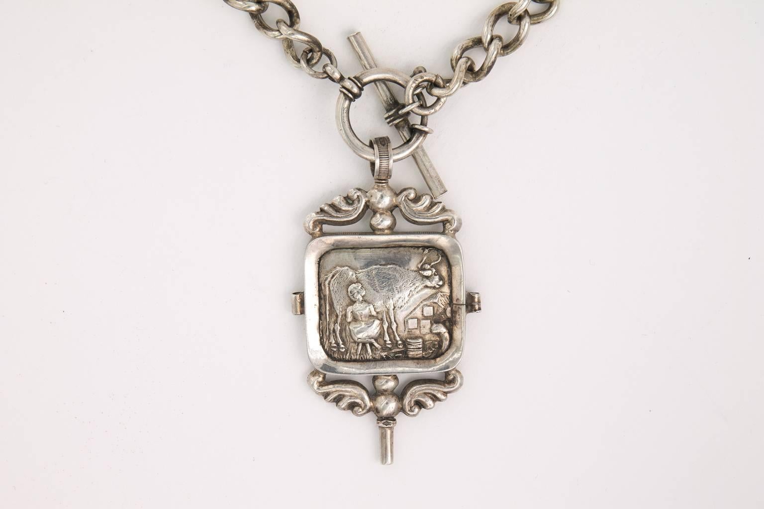 19th Century sterling silver English watch key on sterling silver watch chain turned into necklace. Watch fab depicts milk girl milking cow.
PERIOD:1800-1890
MATERIALS:Silver

