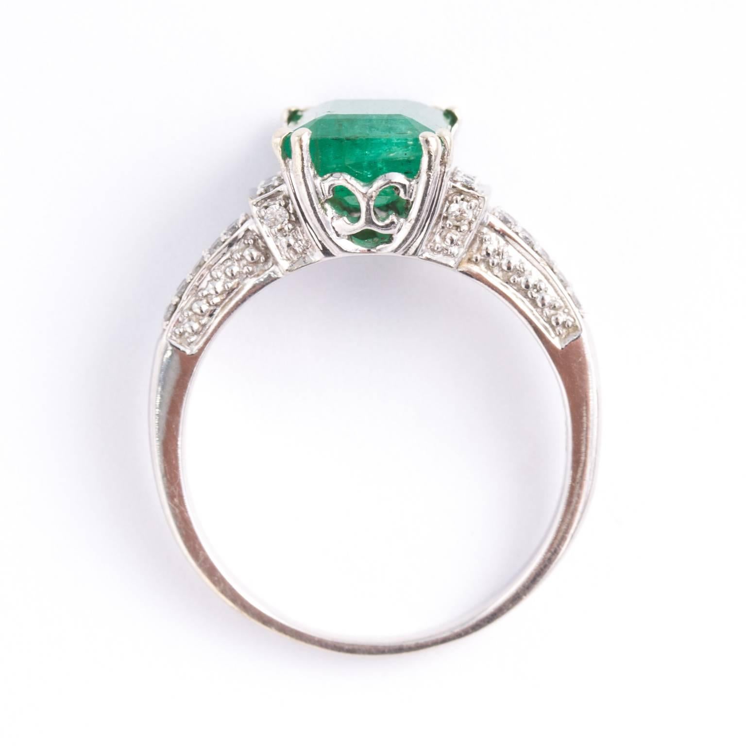  Beautiful ring constructed from solid 14k white gold. (RING SIZE: 8) The ring showcasing a very lovely natural Colombian Emerald, with Saturated rich green color with a slight bluish tint - which is the most desirable green of all emeralds. It is