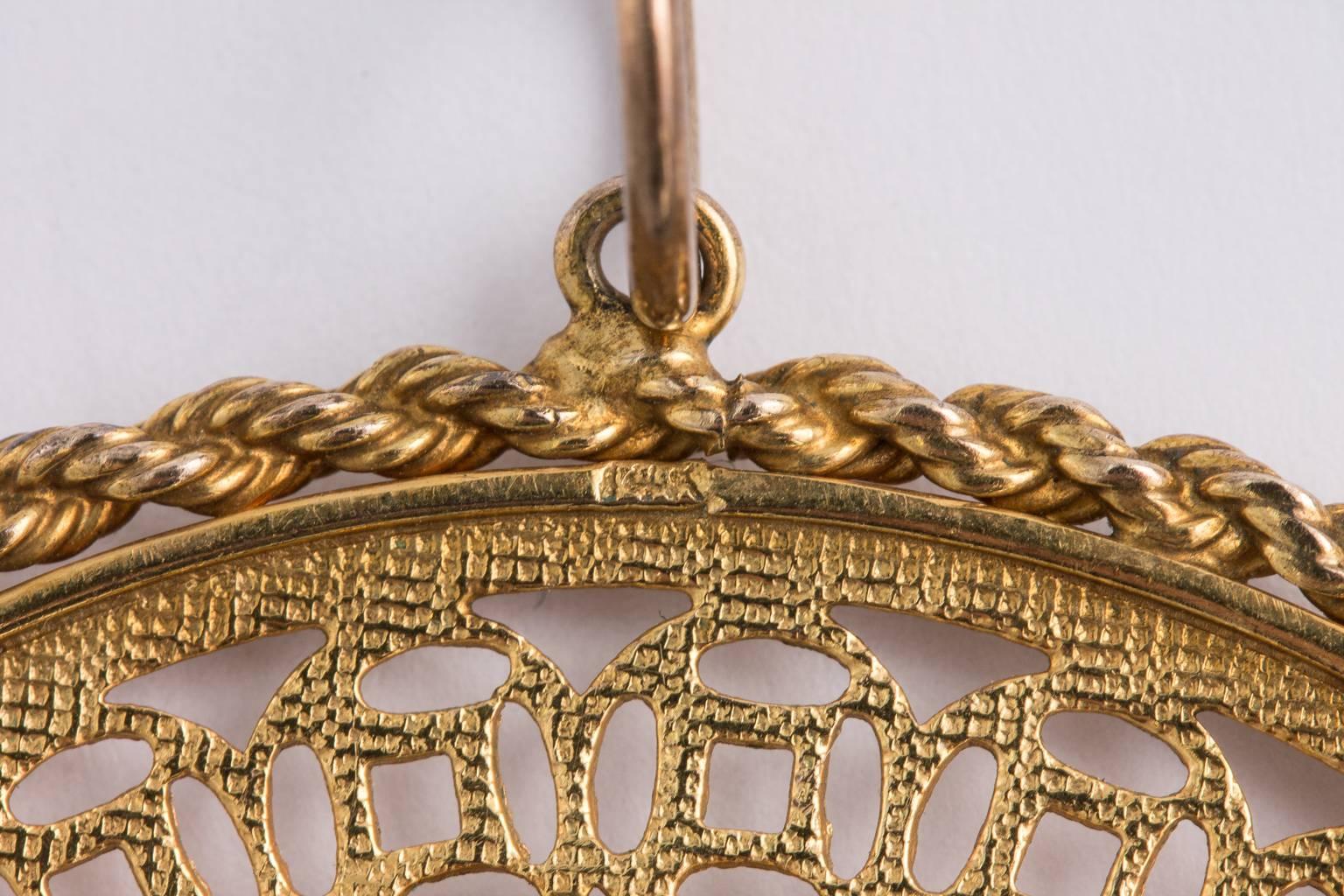 Oriental 14k gold pendant showcasing dragon - phoenix design on one side and Chinese writing on the reverse.