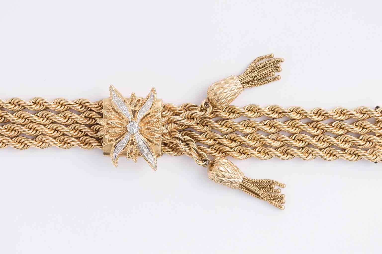 14 K gold four strand bracelet with two tassels and diamond flower on top. 32.4 dwt.- weight
PERIOD:1930-1950
