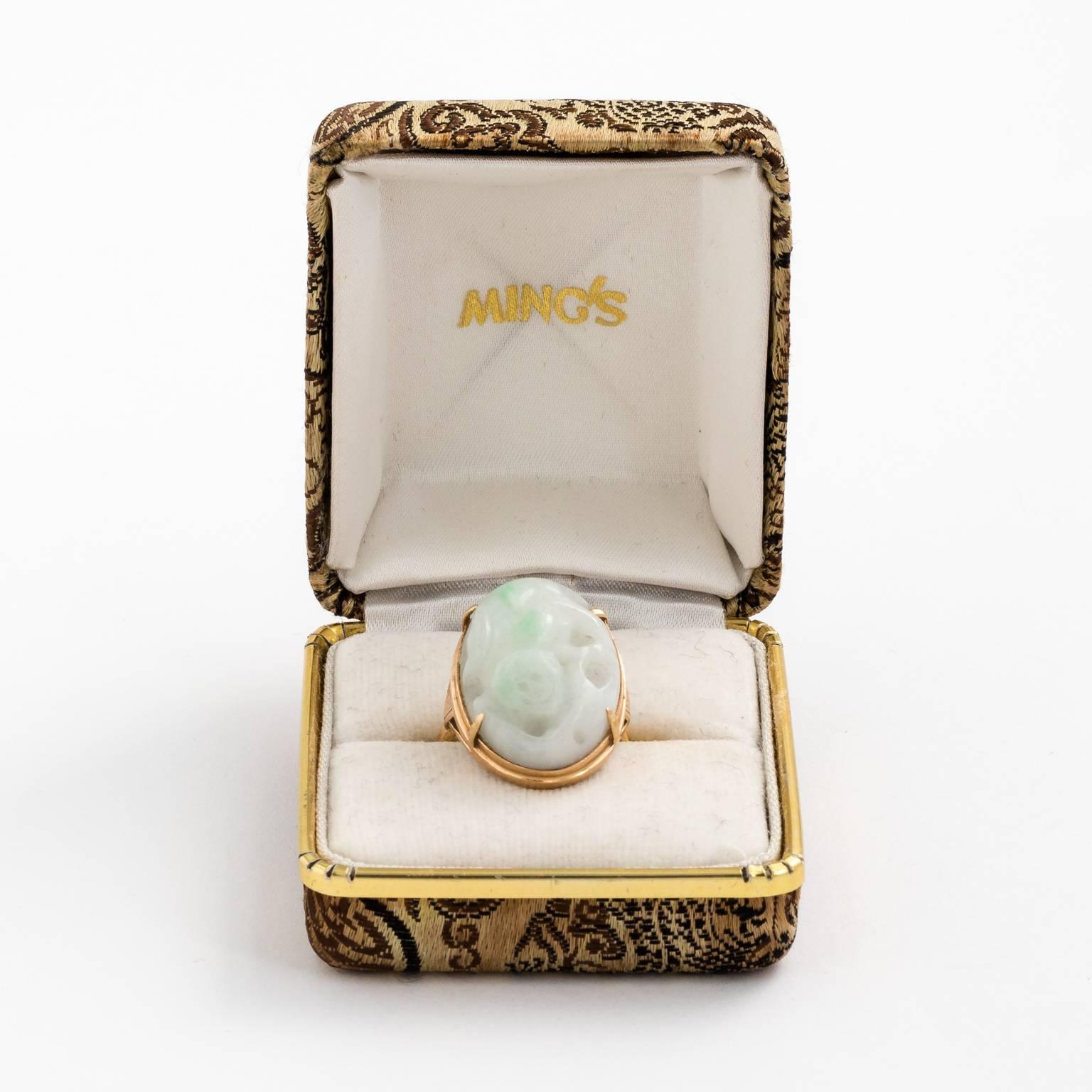 Here is a wonderful signed Ming's of Honolulu Hawaii ring ca.1970. This ring is solid 14k yellow gold with a trademark simple setting. In the center is a large thick carved antique jadeite jade piece depicting what looks like a lucky Bixi. Bixi is a