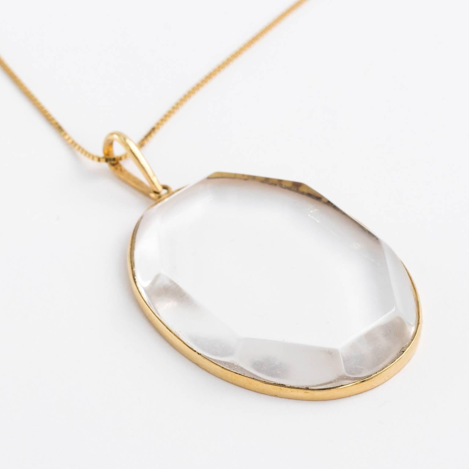 Modernist large crystal rock oval pendant in 18kt setting. The crystal has beveled edge in a hexagonal shape. Pendant come with matching 18kt long 30