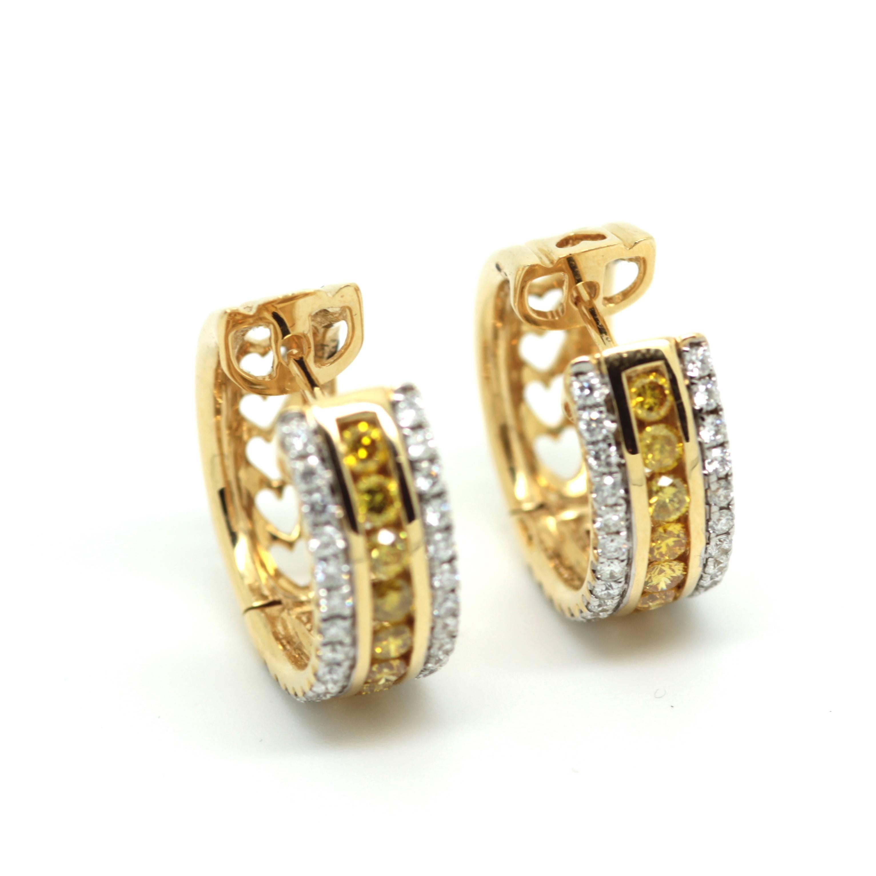 Circular 1.62ct natural fancy yellow and white diamond earrings set in 18k yellow gold.  Price: £ 5950
