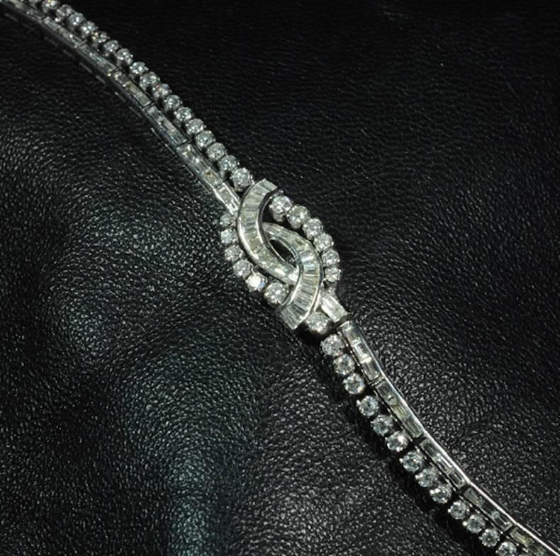 A 1950's round brilliant cut and baguette cut diamond bracelet set in platinum.