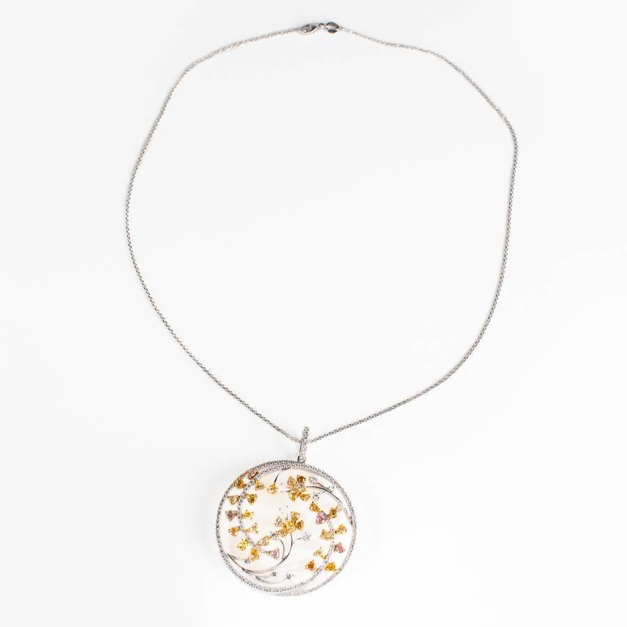 A circular fancy colour diamond pendant set in 18carat white gold.  This piece contains 3.31 carats of diamonds.					