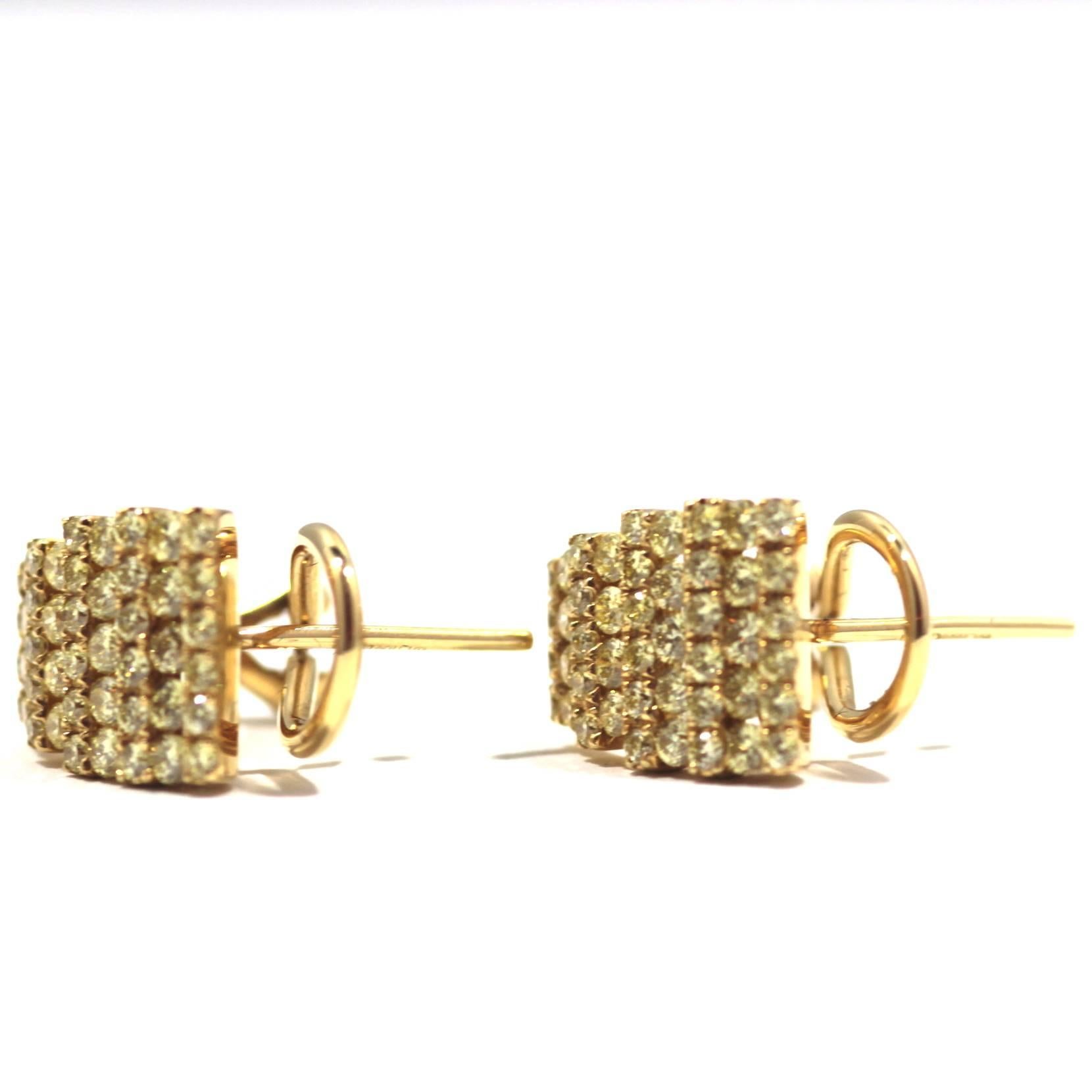 Fancy yellow diamond earrings set in 18ct yellow gold. 1.18carats diamond. 