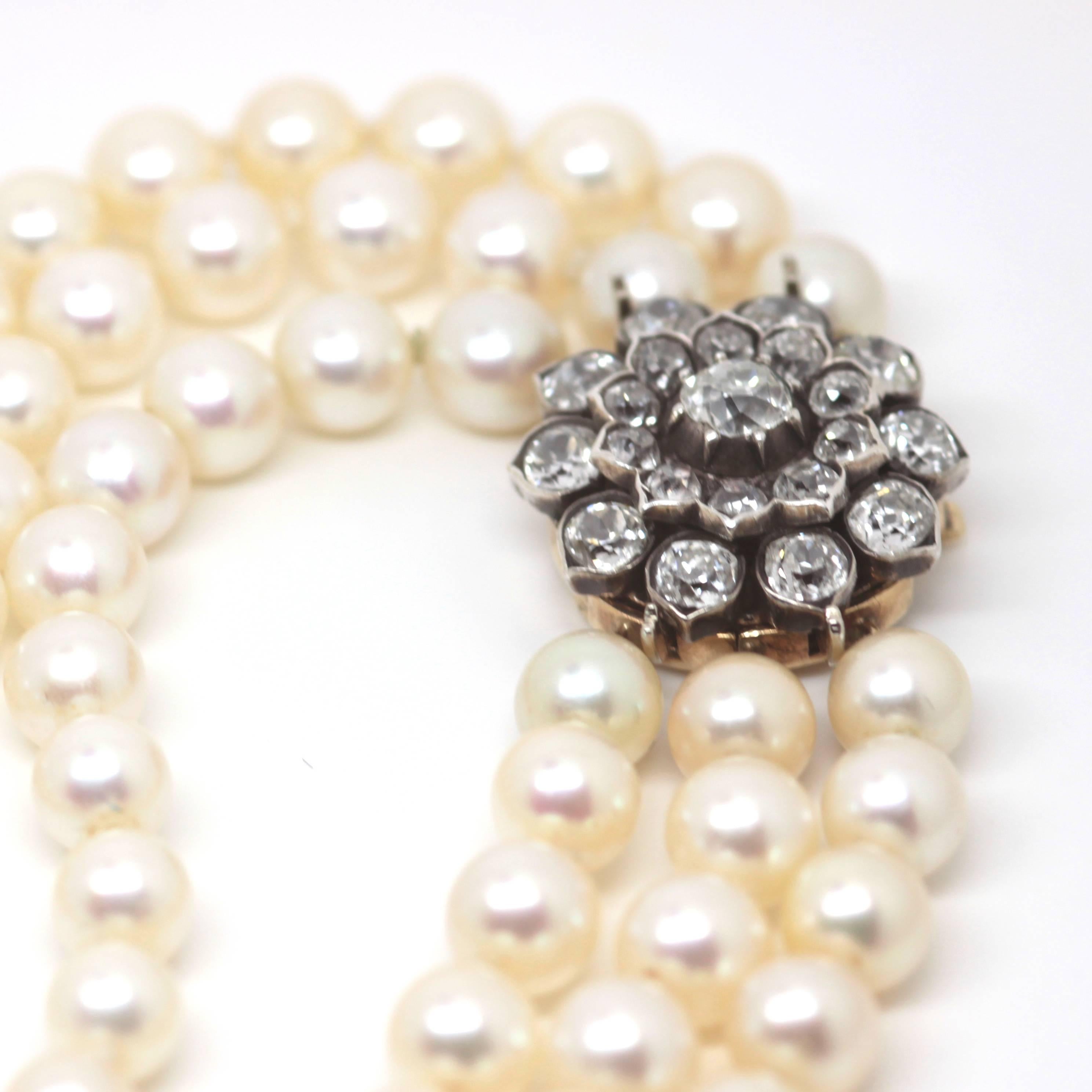Art deco triple strand pearl necklace with an antique diamond clasp containing approximately 2carats of old cut diamonds.  Circa: 1920 
