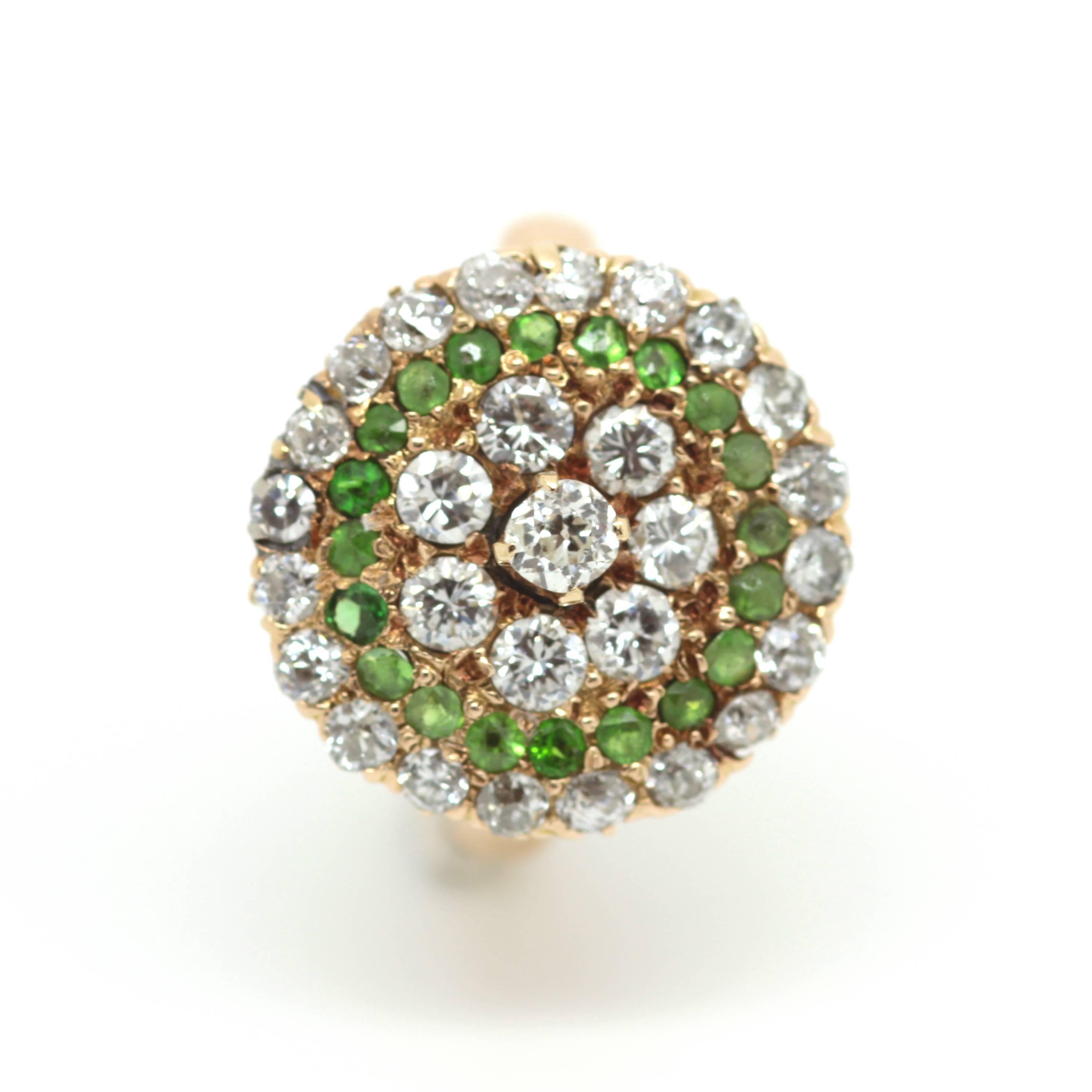 A 1920's Demantoid garnet and diamond cluster ring set in 18ct yellow gold. 
