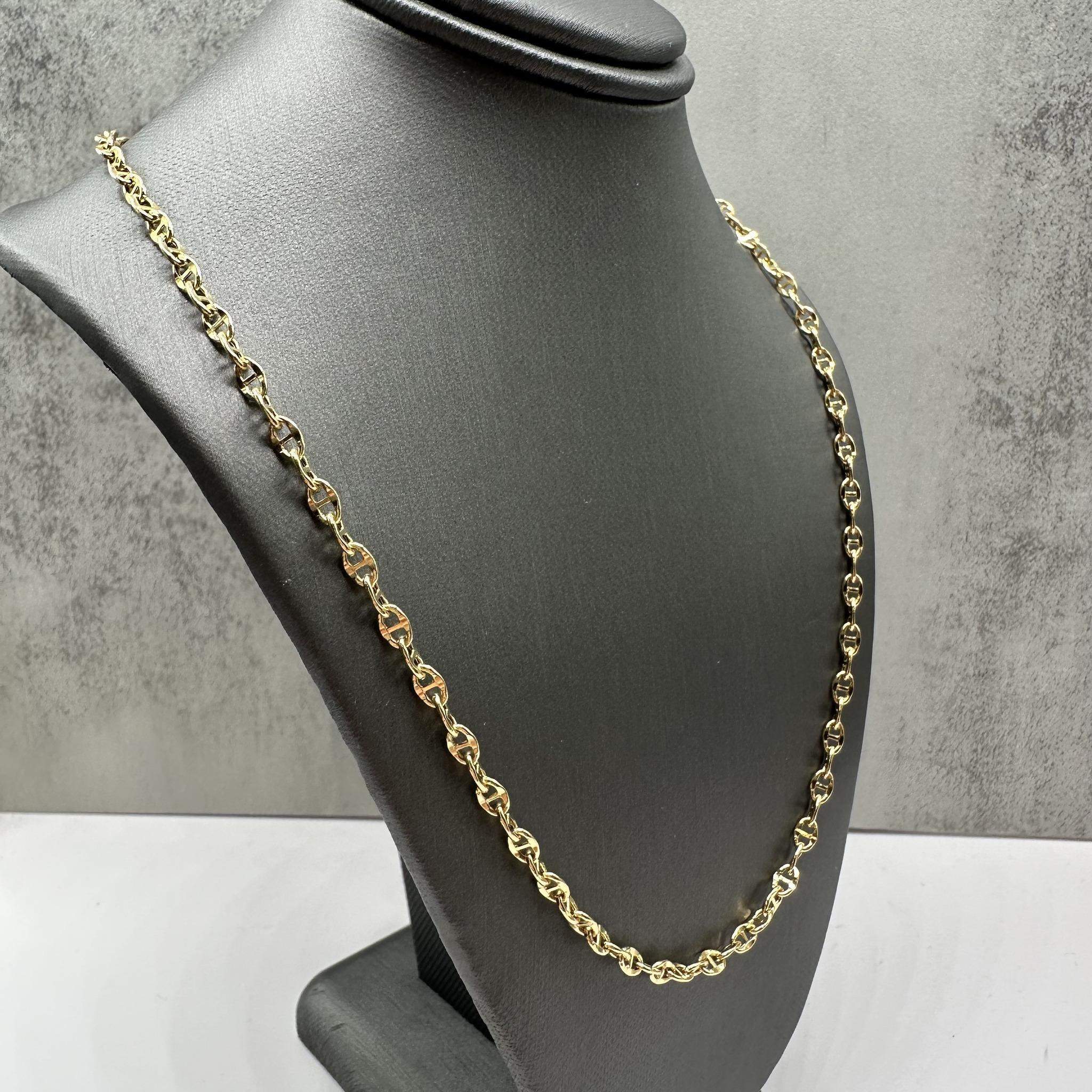 This elegant Mariner Link Chain in 14kt yellow gold features a 3.3mm width and an adjustable length from 18 to 21 inches, making it versatile for different necklines. Weighing 4.1 grams, it provides durability while remaining lightweight due to the