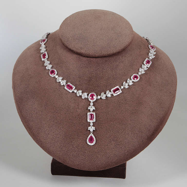20.82 carats of pear, emerald, heart, and oval shaped Burma rubies set with 11.83 carats of diamonds, set in 18k white gold. A gorgeous and unique piece to add to any collection.