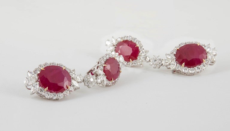A fabulous piece! A rare find!

32.68 carats of Fine Ruby

8.65 carats of White VS Diamonds -- Round, Pear Shape, and Marquise. 

The bottom rubies weigh over 11 carats each and are accompanied by a 
C DUNAIGRE Swiss certificate verifying Burma as