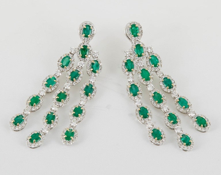 A must have pair of emerald and diamond drop earrings.

7.96 carats of fine oval green emeralds

5.25 carats of white round brilliant cut diamonds

18k white gold