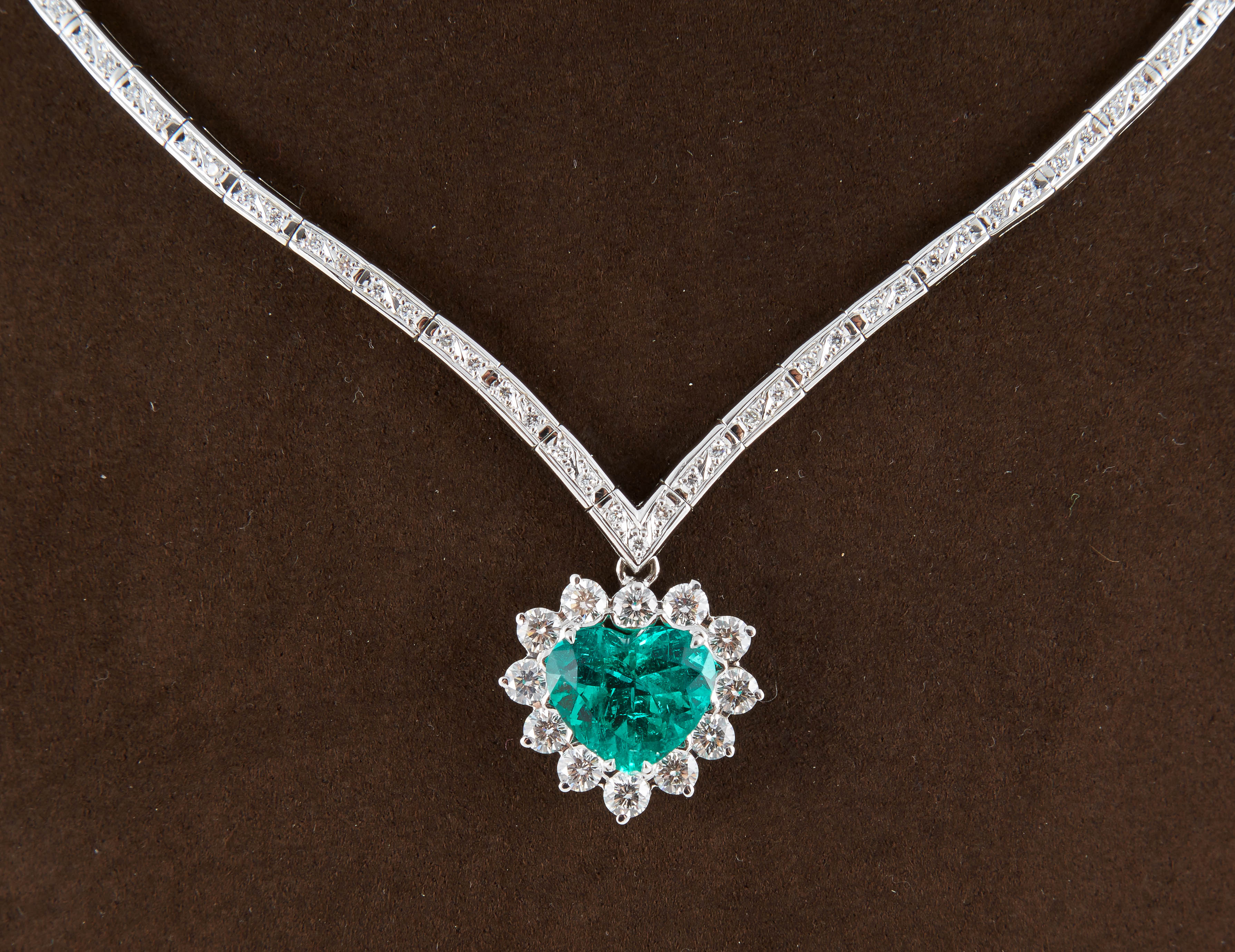 
A stunning and unique piece!

4.81 carat AGL certified Colombian Emerald of exceptional color and clarity. 

Set with 2.45 carats of F color VS clarity diamonds surrounding the emerald and on the 18K white gold necklace.

A Colombian emerald