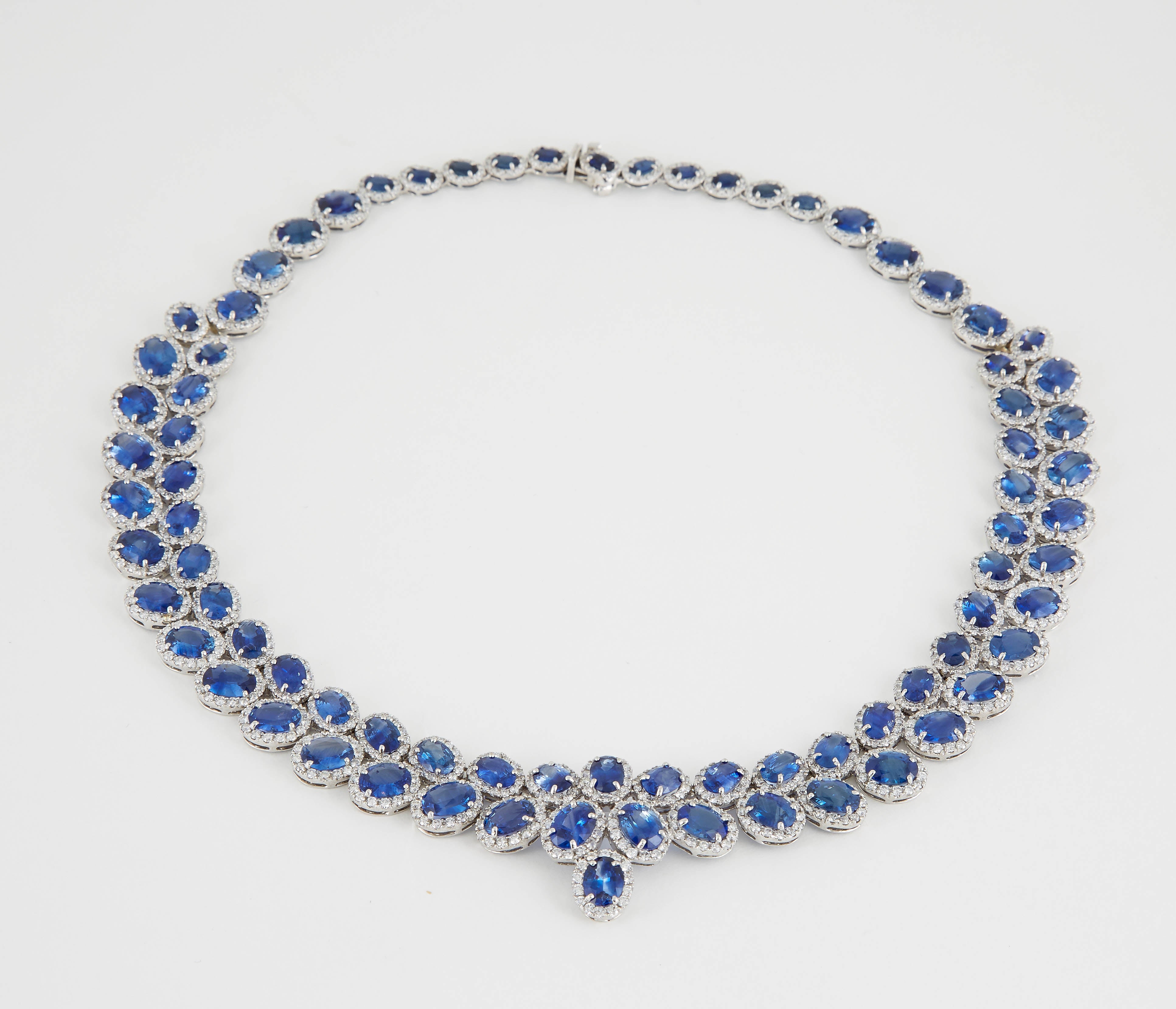 

An incredible piece -- full of sparkle and brilliance!

74.22 carats of fine Ceylon blue sapphires.

15 carats of F/G color VS clarity round brilliant cut diamonds.

18k white gold.