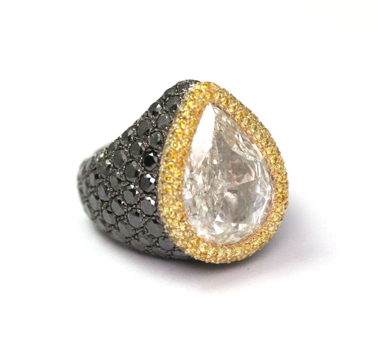 De Grisogono Ring set with a pear shape diamond of 10.85 carats, color I, purity SI2, from the best Belgium laboratory, HRD certificated, surrounded by Fancy yellow and black  diamonds, on a white gold ring,  size 9 ¼ (28,9grs)
This ring is a unique