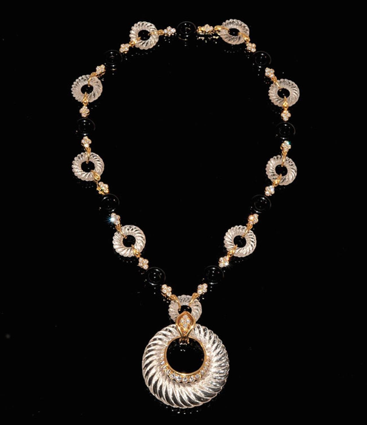 Yellow gold pendant necklace with onyx and rock crystal rings, brilliant-cut diamonds, pendant formed of an elliptical rock crystal enhanced with brilliant-cut diamonds weighing 13 carats, french manufacturer André Vassort hallmark, numbers 8374 and