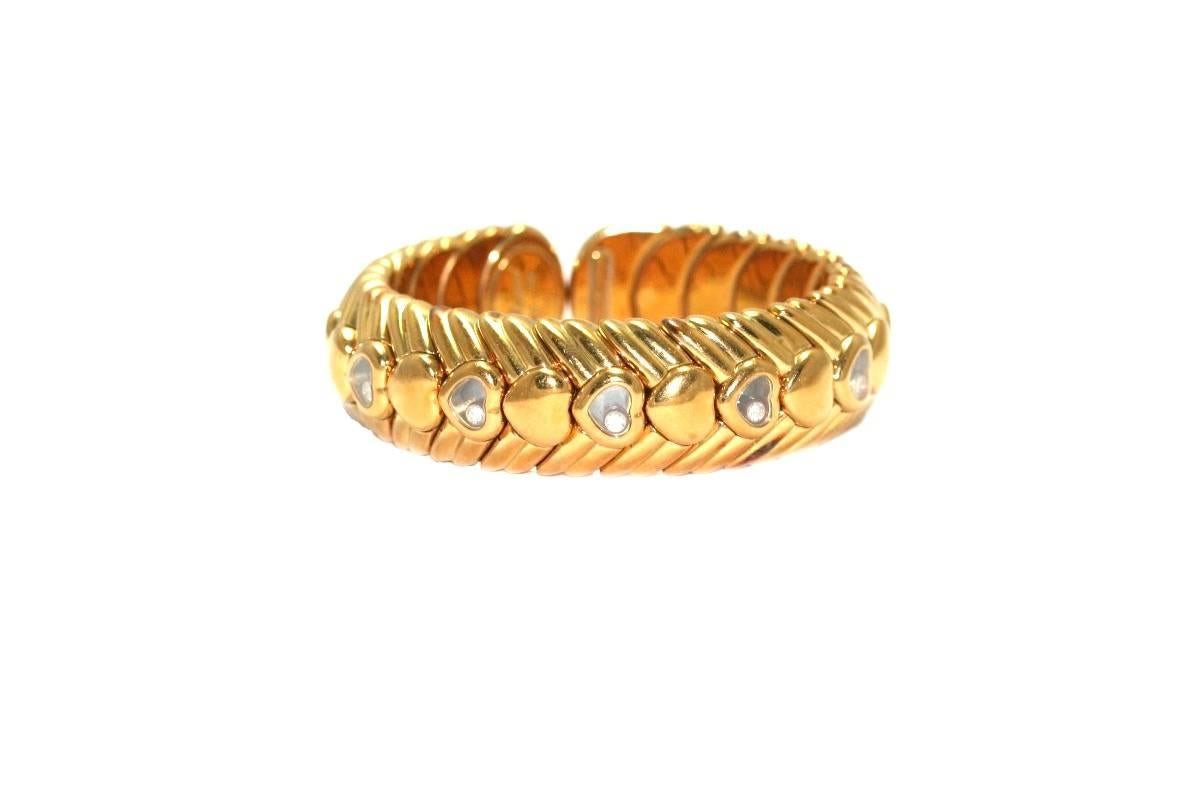 CHOPARD Semi-rigid  bracelet in yellow gold, with mobile diamonds hearts patterns, signed. 
119.60 grammes
