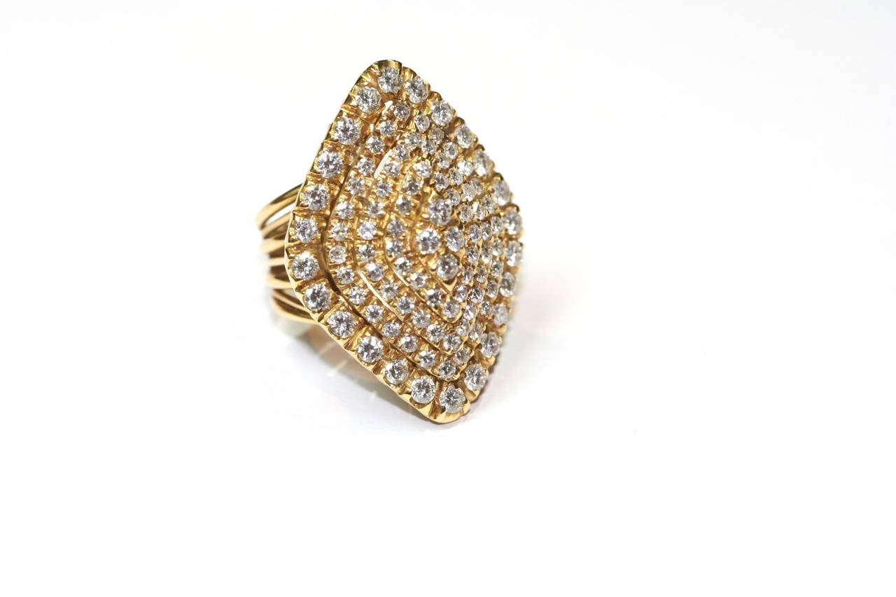 Dome yellow gold ring, set with 5 rows of brilliant-cut diamonds weighing approximately five carats, forming a rhombus shape.  
Ring size : 52,5 (French size) resizable. 
Ring weight : 17 grams
