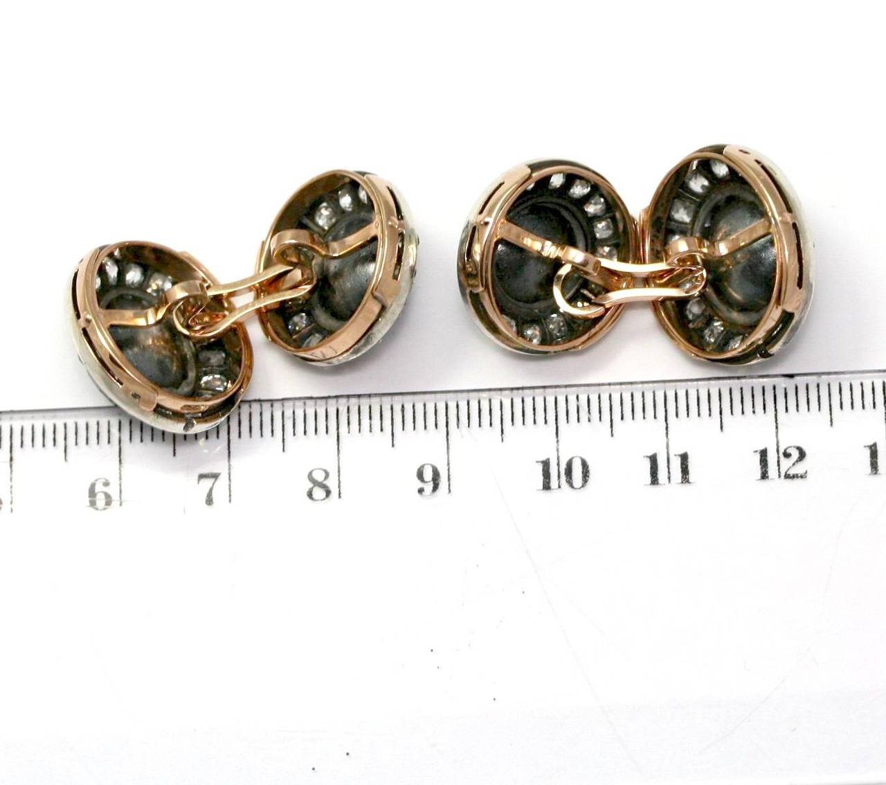 Cufflinks set with faceted sapphires circled with old cut diamonds, mounting in yellow gold, silver (26,3 grams)
