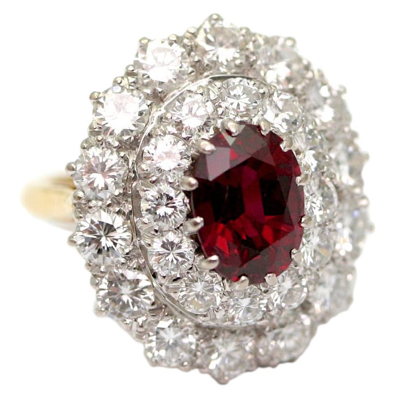 Platinum and yellow gold ring, set on its center with an oval cut Thailand's ruby of 2,69 carats and two rows of diamonds, adjustable ring size 4 (8,05grams) 