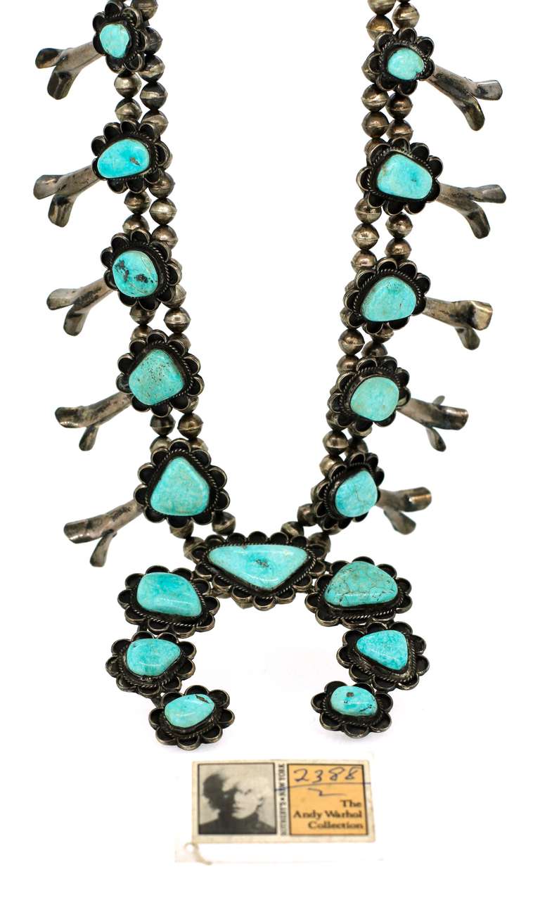 Navajo Squash Blossom necklace in silver set with turquoise, decorated with silver charms, the central piece an open circular pattern. Provenance: personally belonged to Andy Warhol, Sotheby's 1988 sale, Dimensions 69 x 9cm (190,5grs)