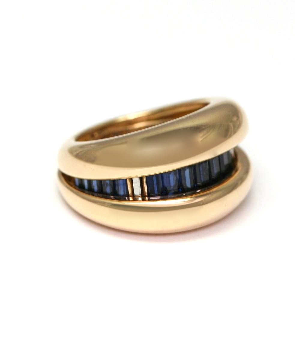 POIRAY 'Day and night' yellow gold ring set with a line of tapers sapphires, signed and numbered 5040, ring size 3 3/4, with Poiray case (13.2 grams)