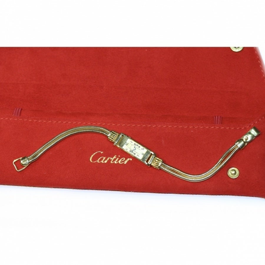 Wristwatch in yellow gold, rectangular case, dial with Arabic numerals, Duoplan mechanical movement , wrist with two strands, signed Cartier 27865 30068 05250,185mm in a Cartier sued pouch (27.50 grams)