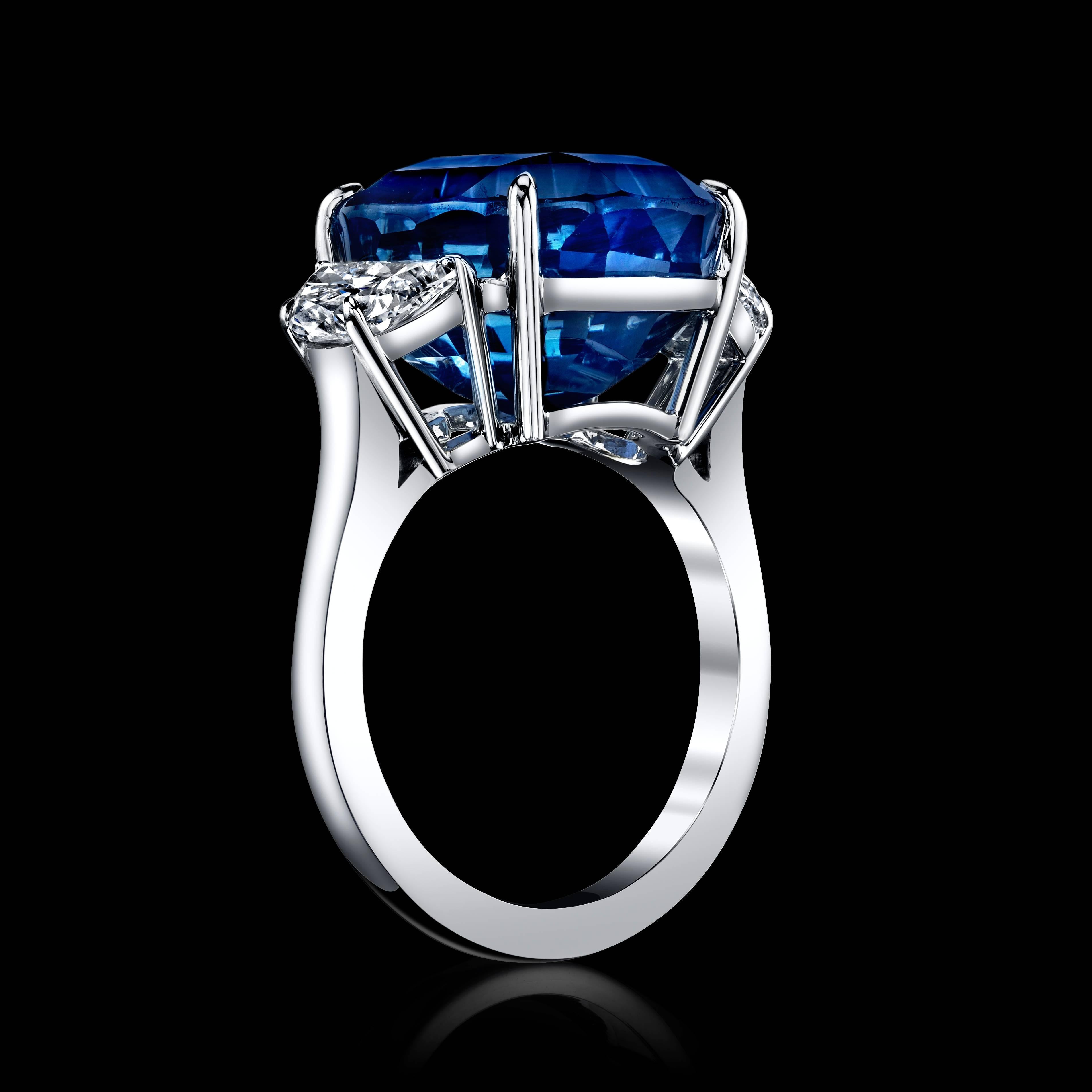 Handmade platinum cushion cut Sapphire and Diamond ring. The blue sapphire is cushion cut, with a weight of 16.33 carats, and is certified as unheated and Sri Lankan origin. 
The center Sapphire is surrounded by two diamond half-moons, weighting a